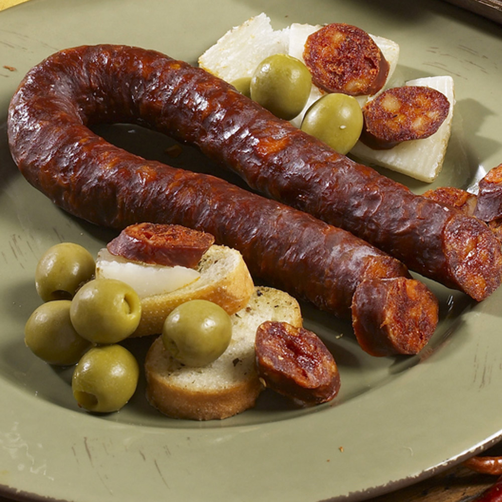 palacios picante chorizo on plate with olives and bread