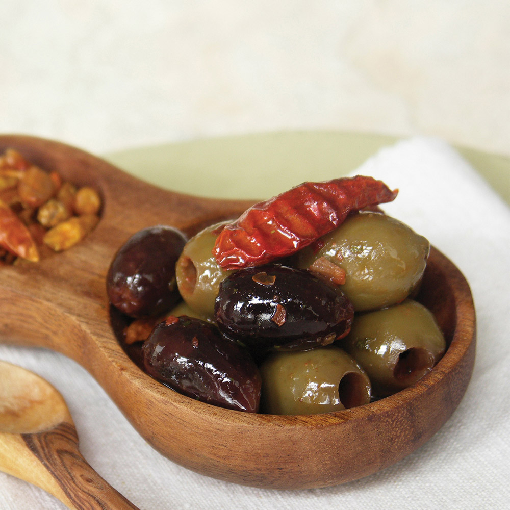 divina pitted crushed chile marinated greek olive mix in bowl with spices