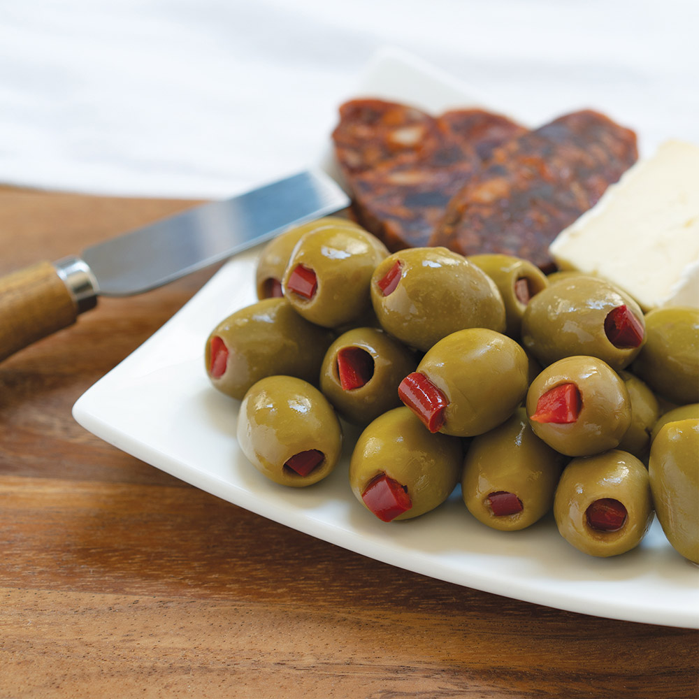divina green olives stuffed with red peppers on plate