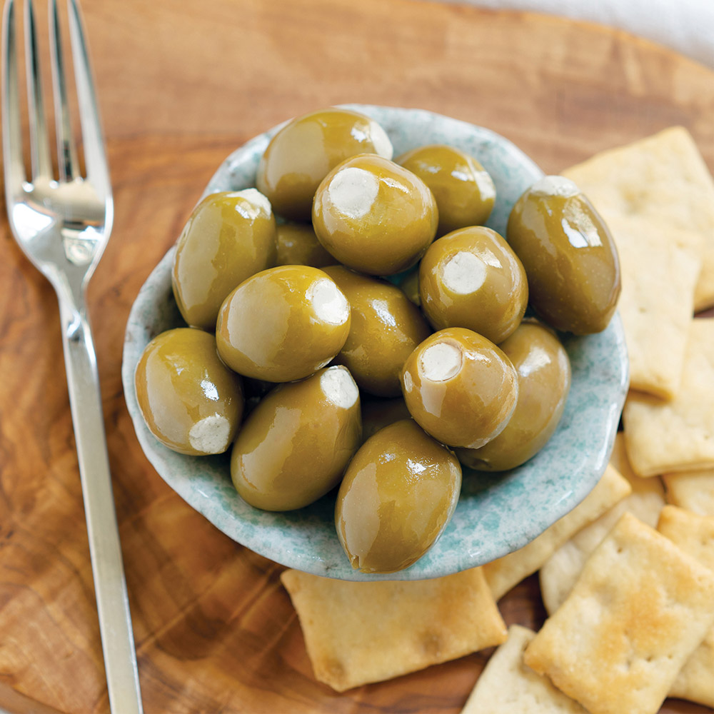 divina green olives stuffed with blue cheese in bowl with fork