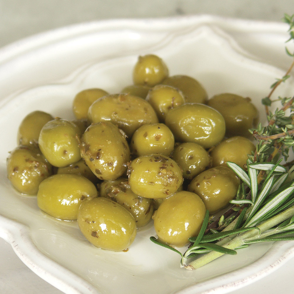 Barnier green olives with herbes de provence on a plate with garnish