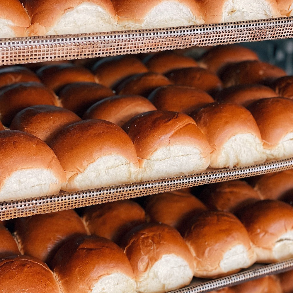 Mediterra bakehouse sliced challah hamburger buns on a rack