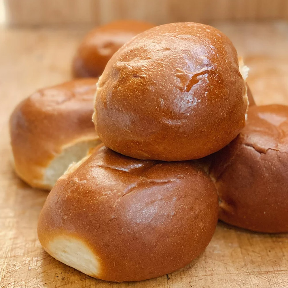 Five pieces of Mediterra bakehouse unsliced challah hamburger buns