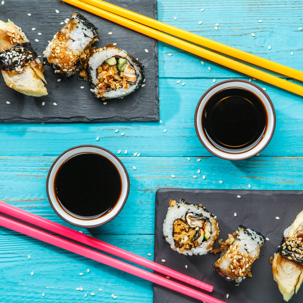 Sushi with chopsticks and bowls of soy sauce