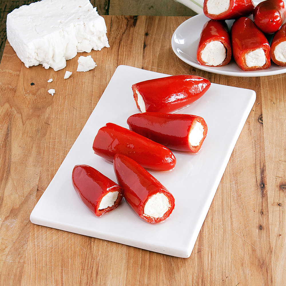 Divina red kardoula peppers stuffed with feta on cutting board