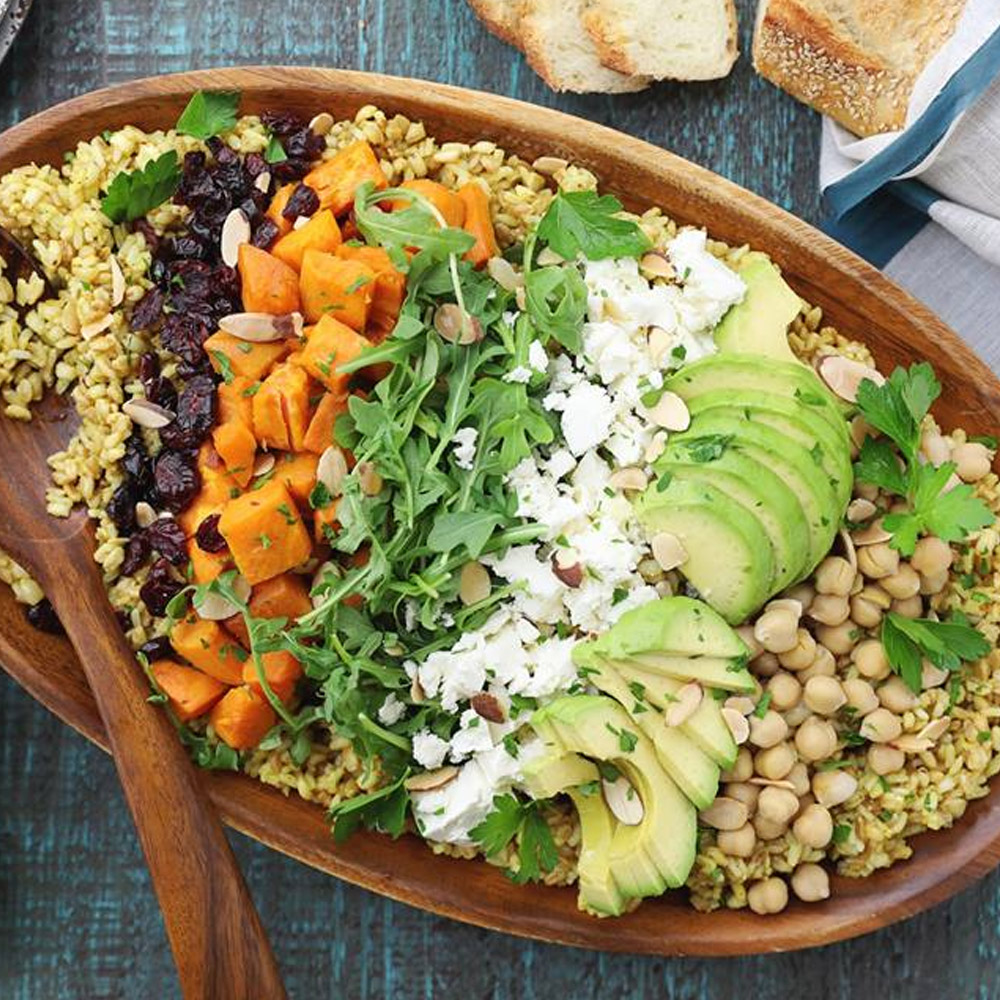 A colorful salad made with Agribosco Organic 10 Minute Ancient Grain Blend in a wooden bowl