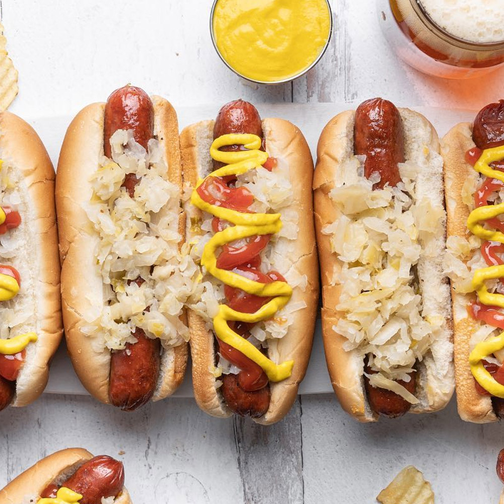 Hot dogs with ketchup and mustard topped with sauerkraut