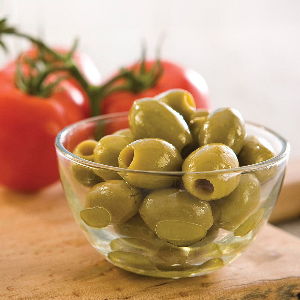 divina organic pitted green olives in bowl