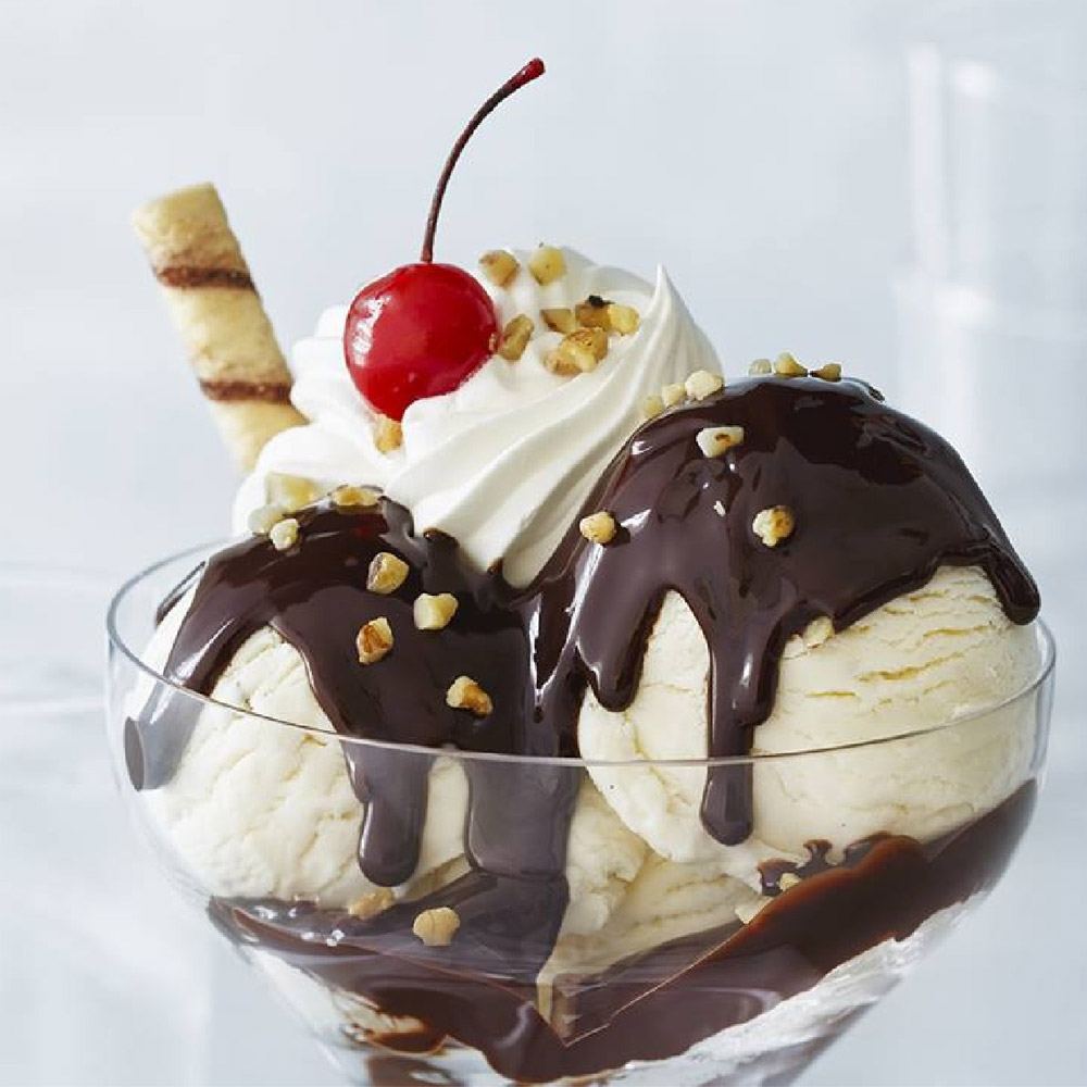 An ice cream sundae topped with Ghirardelli Hot Fudge Sauce