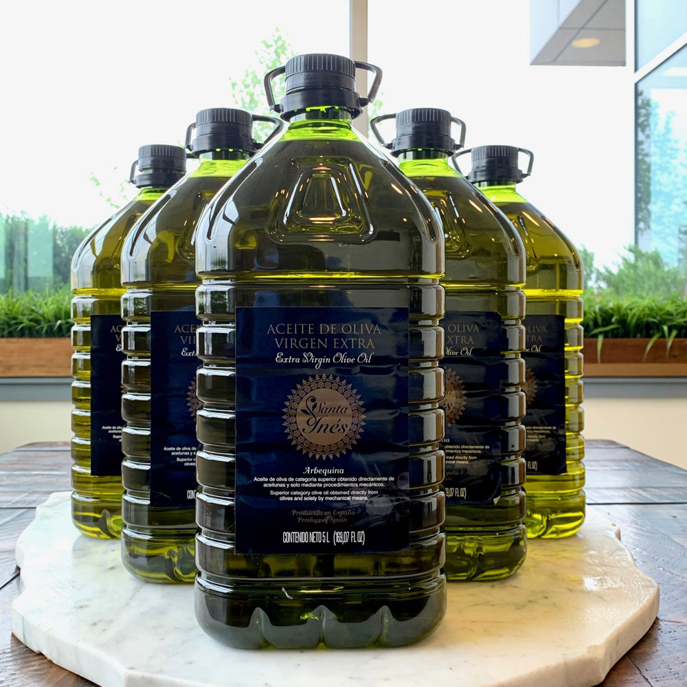 five bottles of santa ines arbequina extra virgin olive oil in V shaped formation