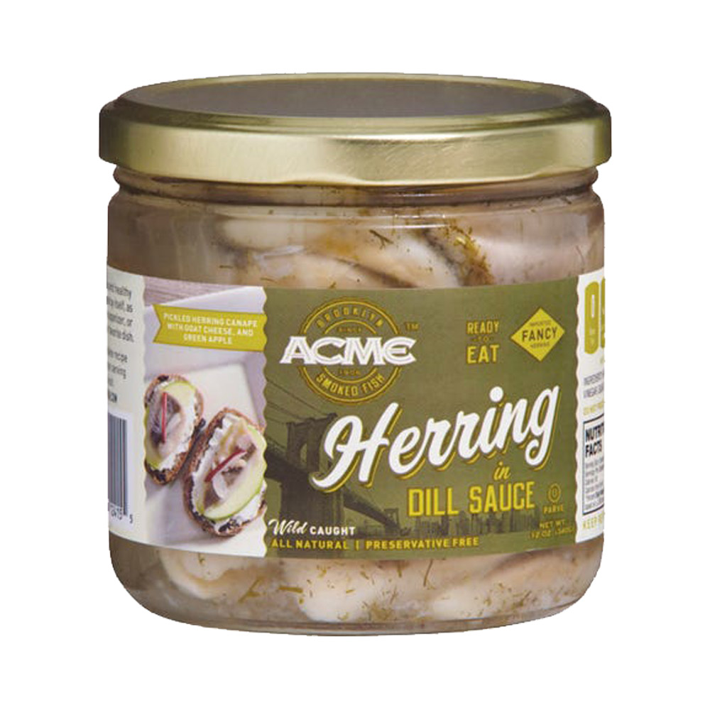 A glass jar of Acme herring in dill sauce