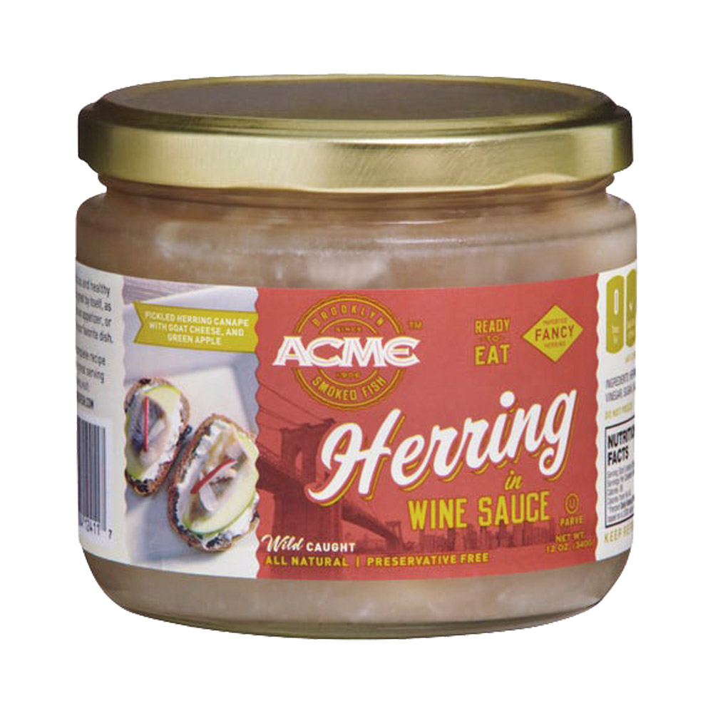 A glass jar of Acme herring in wine sauce
