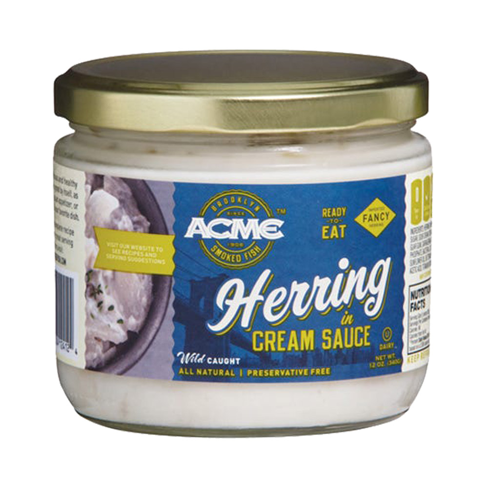 A glass jar of Acme herring in cream sauce