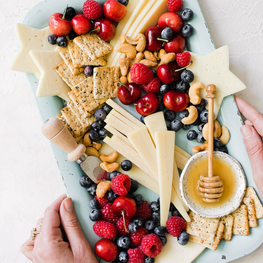 A patriotic cheese board with havarti and fruit