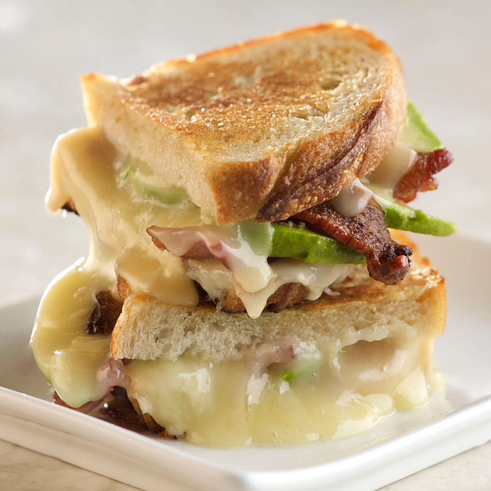 A grilled cheese bacon and avocado sandwich