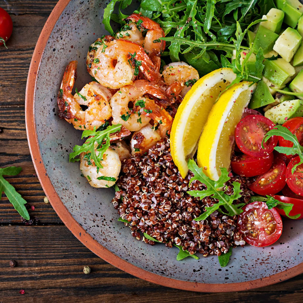 A Salad with shrimp and quinoa and avocado