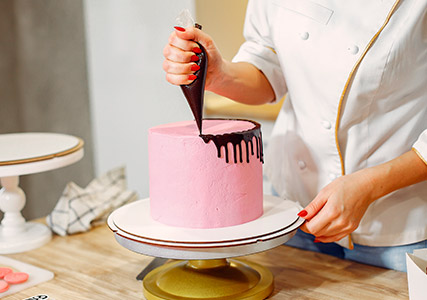 A woman decorating a cake