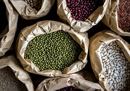 Overhead shot of beans, grains, and rice in bags