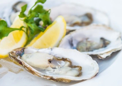 Oysters shucked with lemon wedges